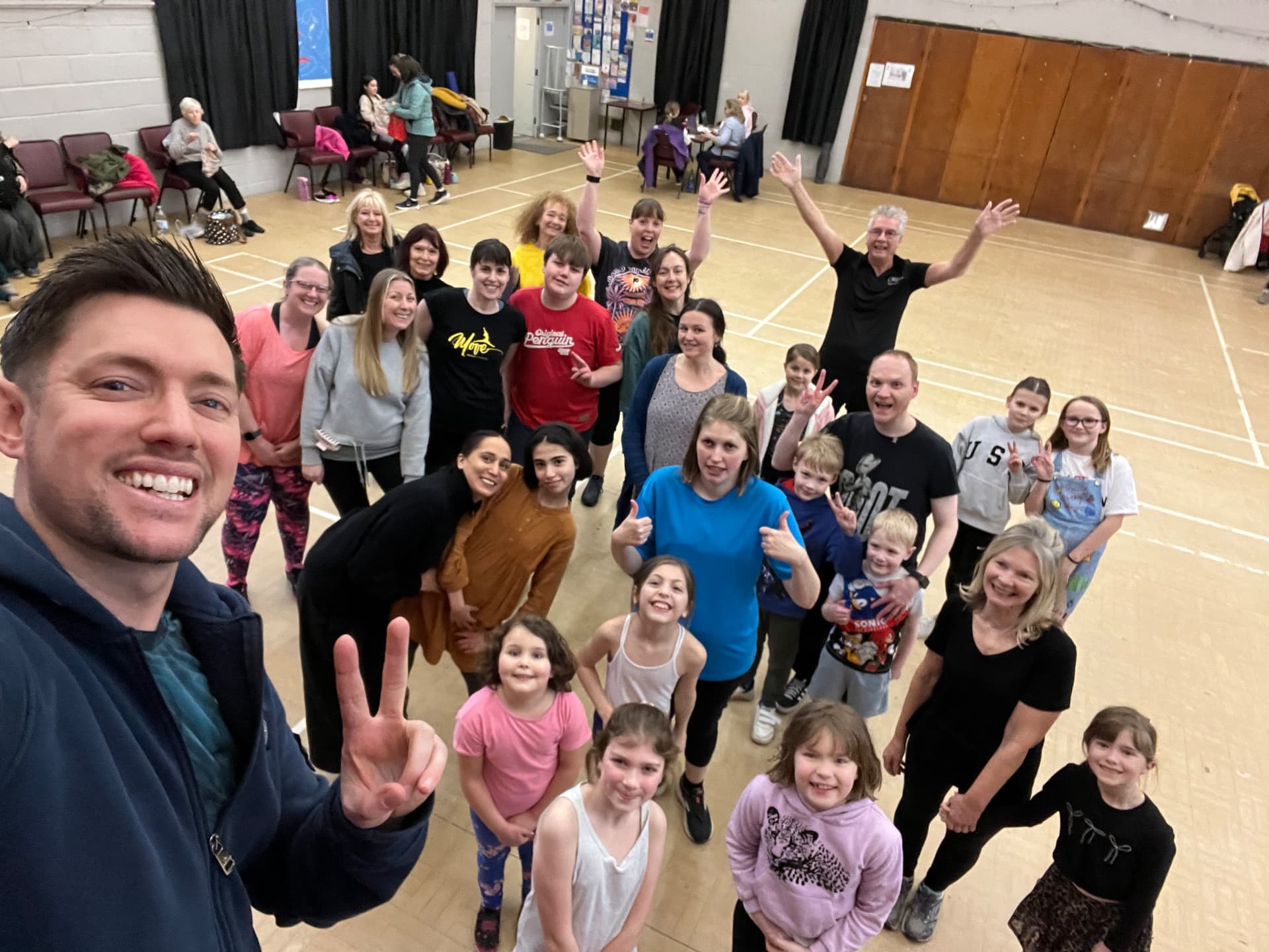 Jason with a full class of smiling participants after a Zumba session in Cornwall