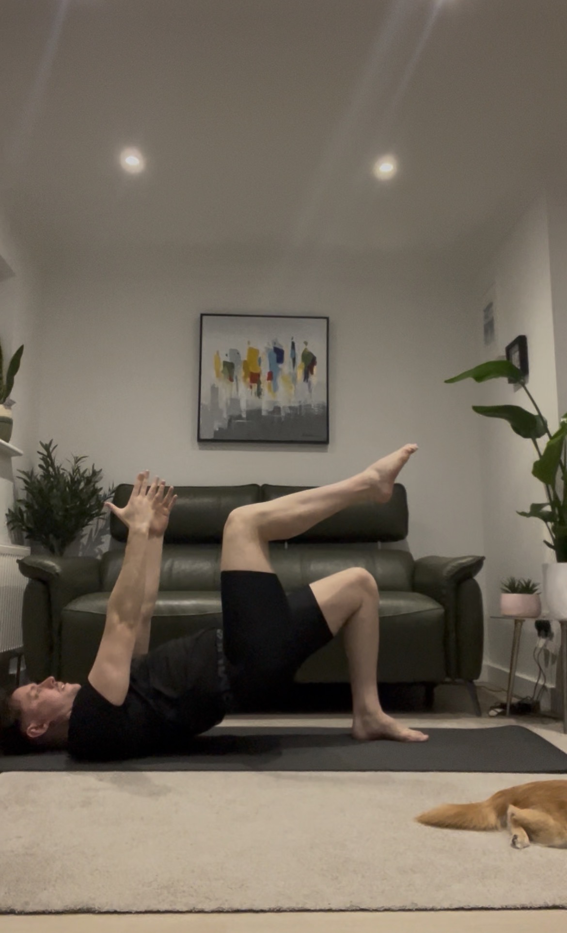 Jason demonstrating a bridge with tabletop leg lift on the mat
