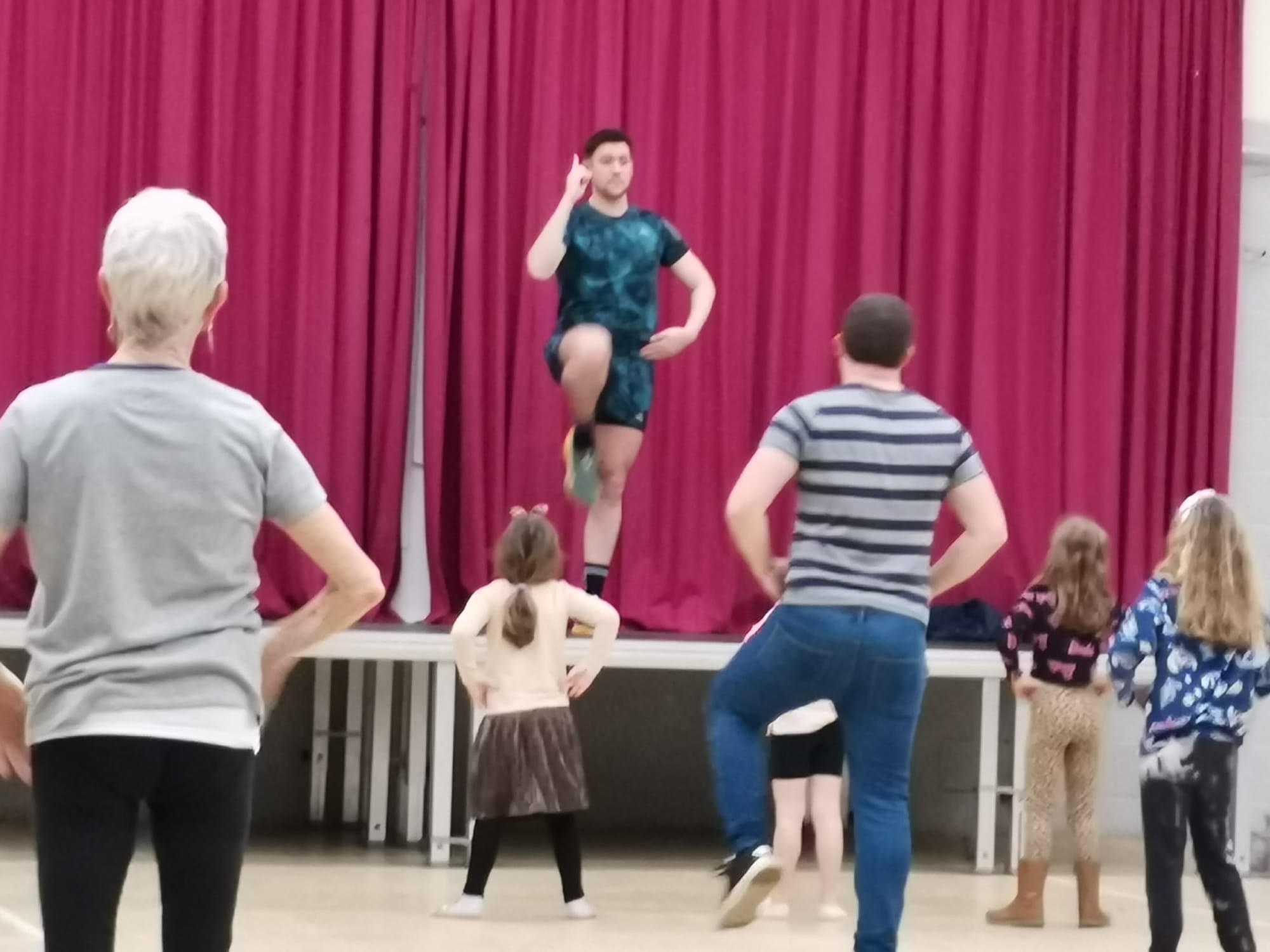 Jason leading a Zumba routine from the stage