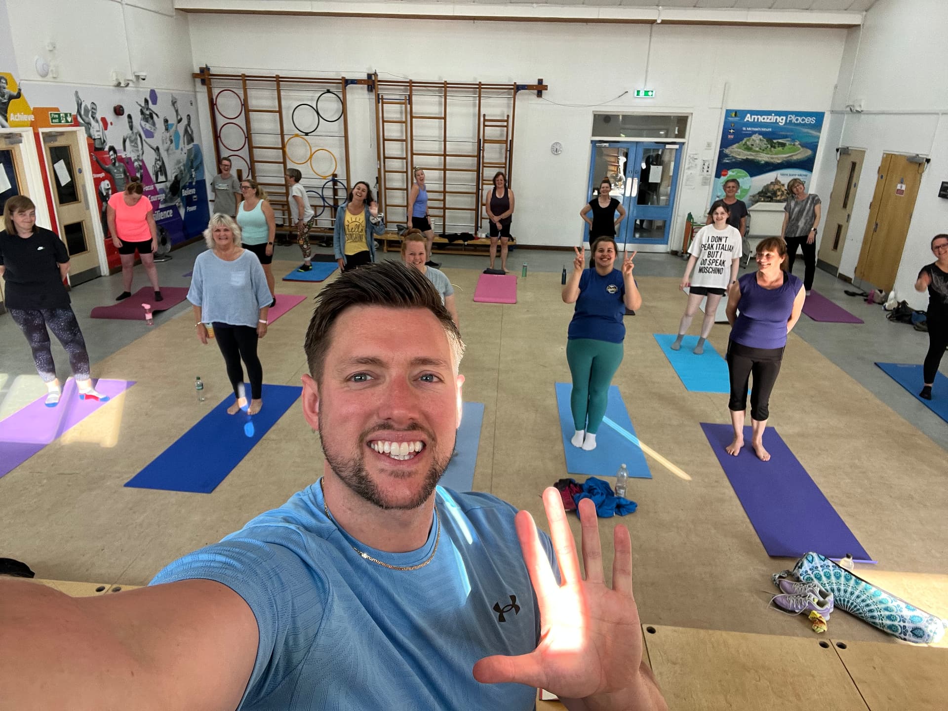 Jason taking a selfie with his mat Pilates class behind him